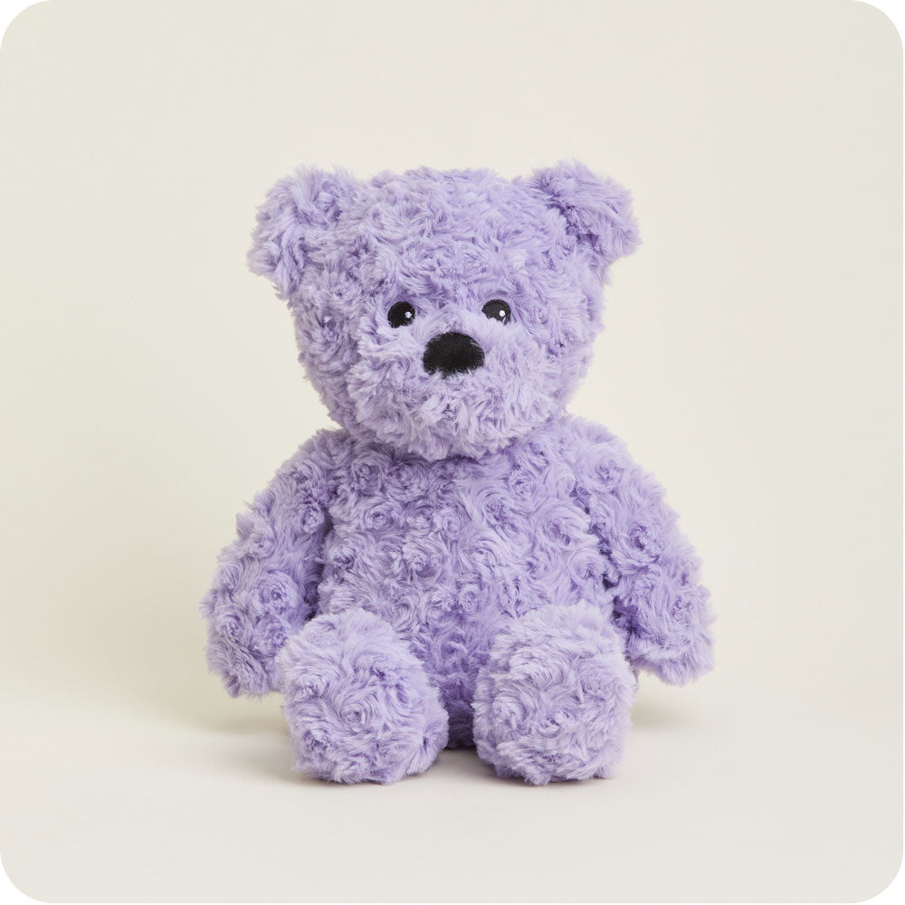 purple curly bear plush toy on a gray background