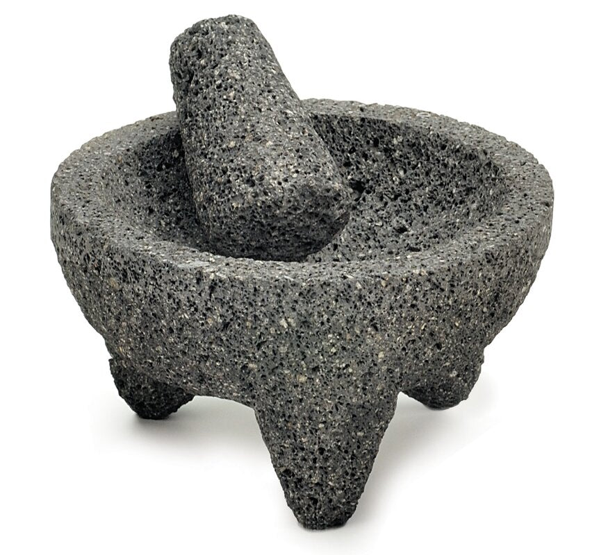 top view of Molcajete and tejolote on white background.