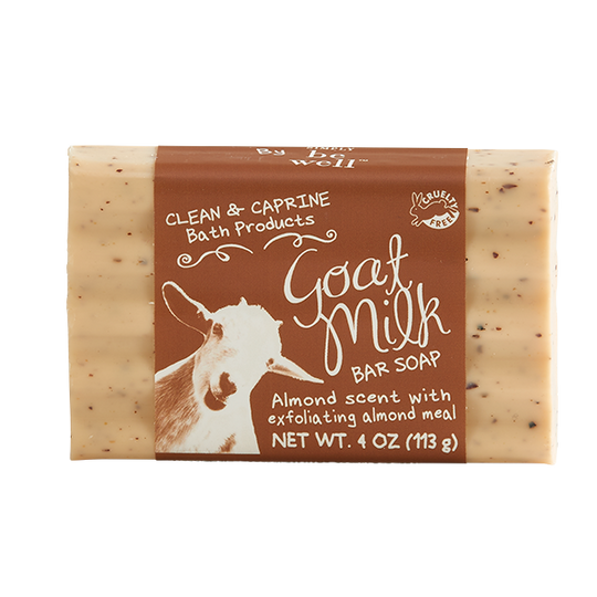 bar of soap with brown paper wrapper on white background. wrapper has image of a goat's face in bottom left corner, the text "clean & caprine bath products" in top corner, and "goat milk bar soap" in center.
