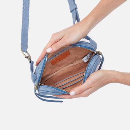 hands holding open provence blue shaker belt bag showing interior.
