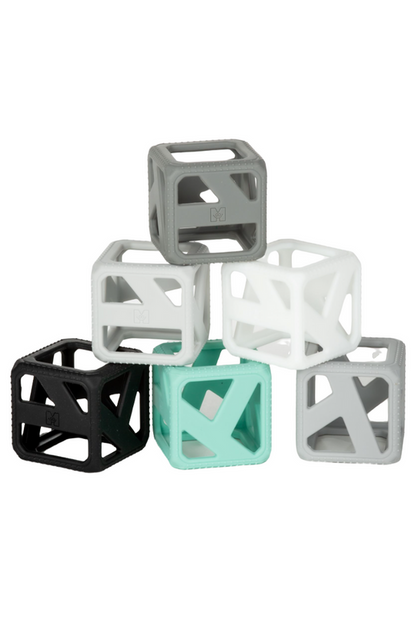 monochrome stack n chew block are gray, white, turquoise, and black stacked against a white background