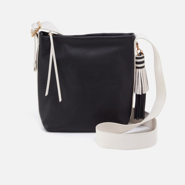 black bag with white strap and black and white tassel.