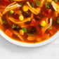 a bowl of south of the border tortilla soup on a white background