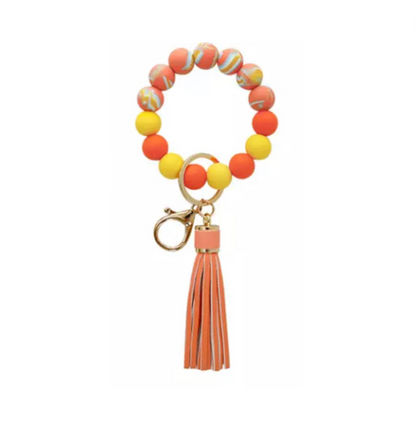 colorful silicone beaded bracelet with orange tassel.