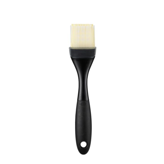 pastry brush with off-white bristles and black handle.