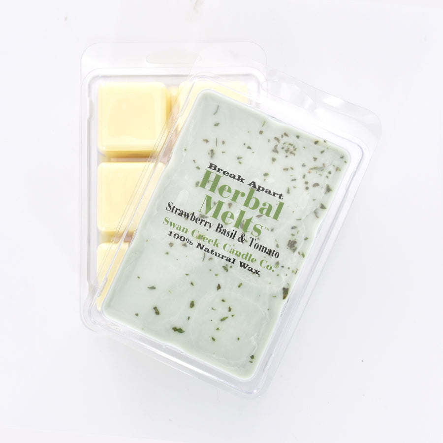 mint green wax with dried herbs on top in packaging with another package showing the bottom of the wax melts break apart design.