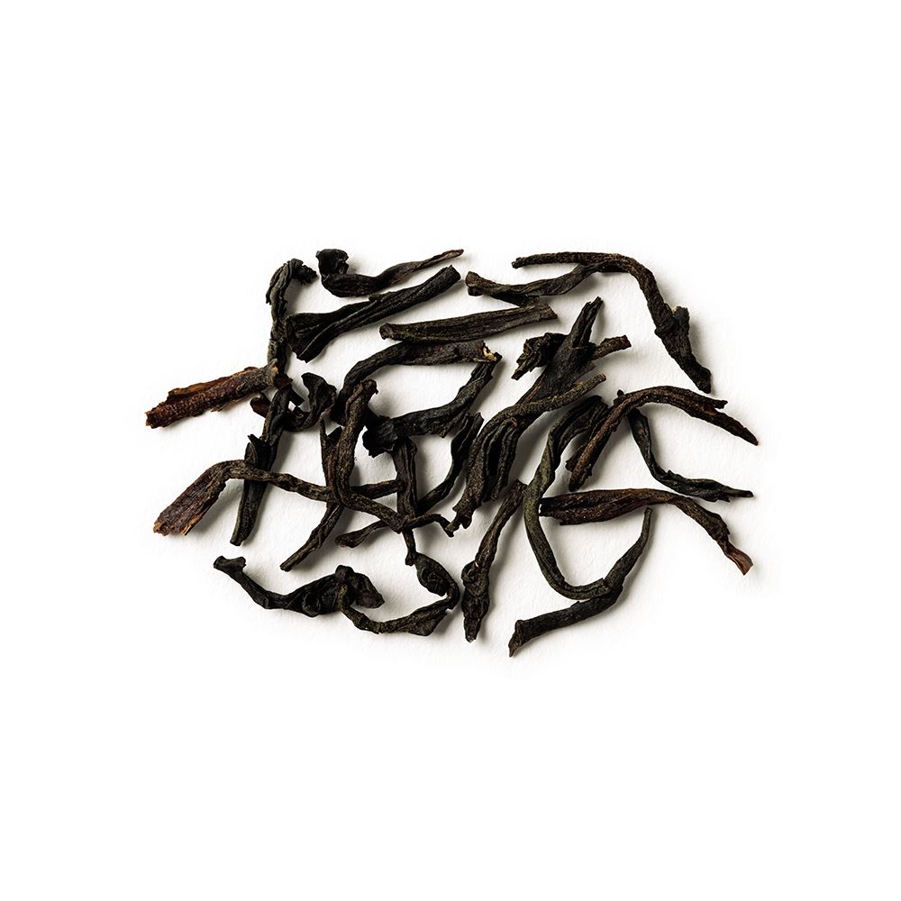 earl greyer full loose leaf black tea scattered on a white background