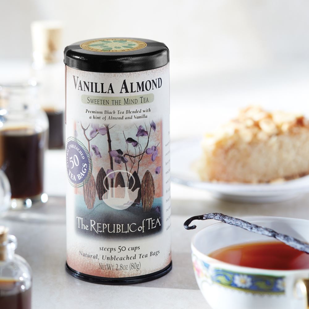 vanilla almond black tea canister displayed on a table setting next to a slice of pie and cup of tea