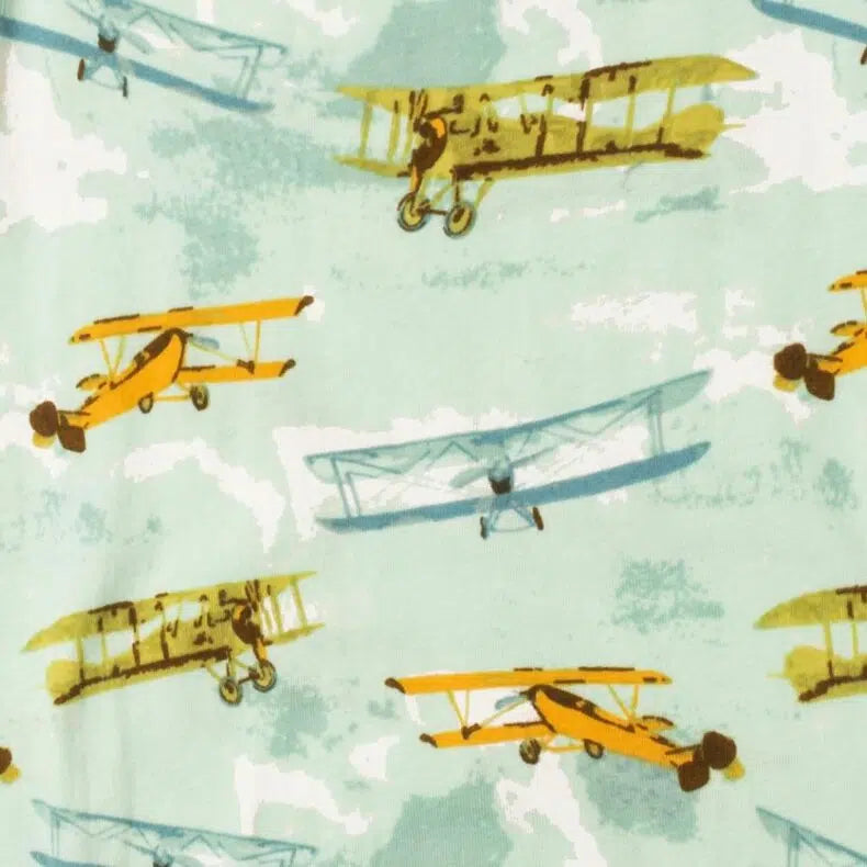 close-up of light blue fabric with all-over pattern of vintage planes.