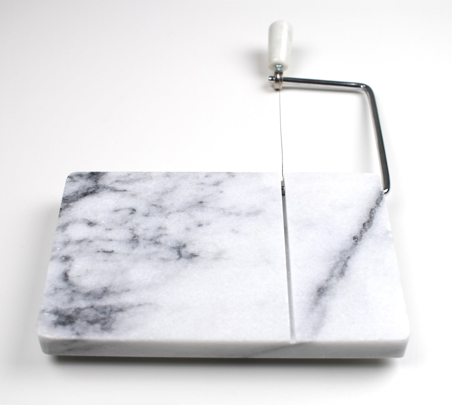 marble cheese slicer with handle lifted.