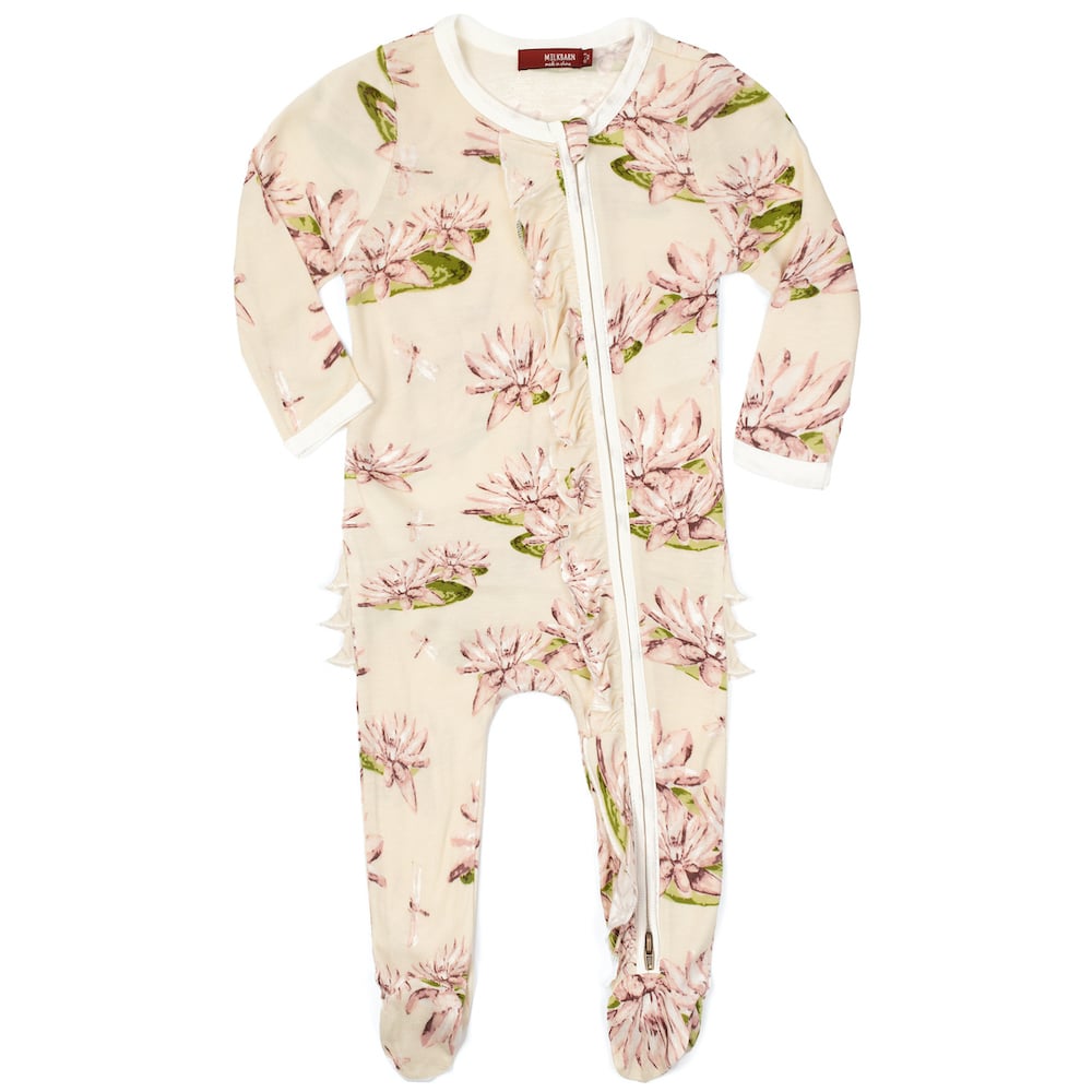 water lily ruffle footed romper is light purple with lily flowers all over displayed on a white background