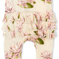 close up view of the ruffle bottom of the water lily ruffle footed romper displayed on a white background