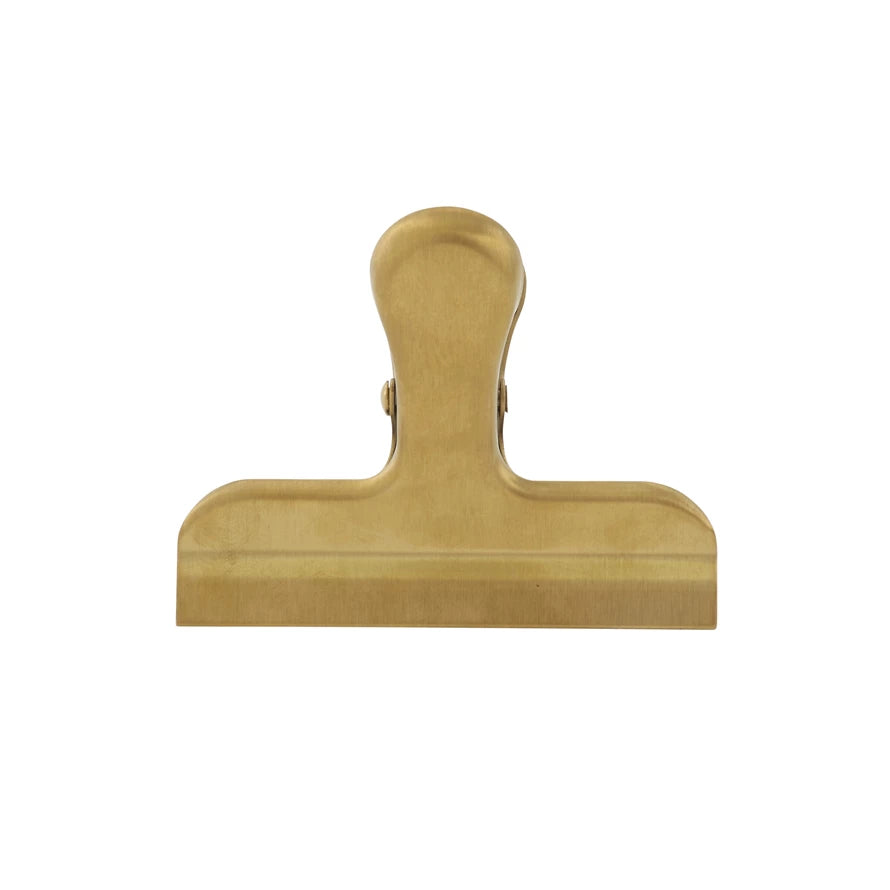 brass colored stainless steel clip on a white background