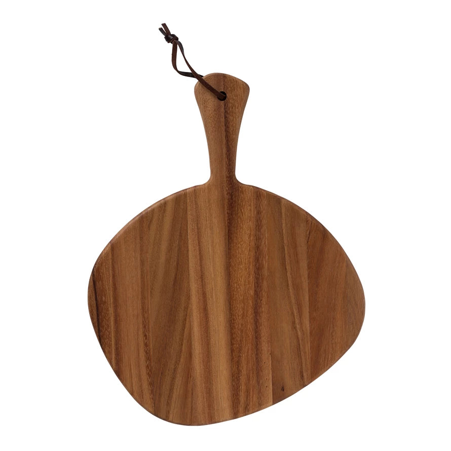 odd shaped circular wood board with handle and leather strap on a white background.