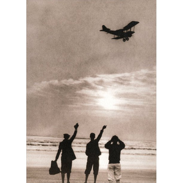 front of card is a photograph of three people waving at an airplane flying over the ocean
