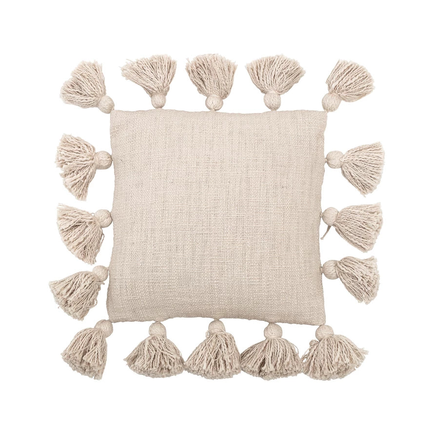 tan slub pillow with tassels on a white background