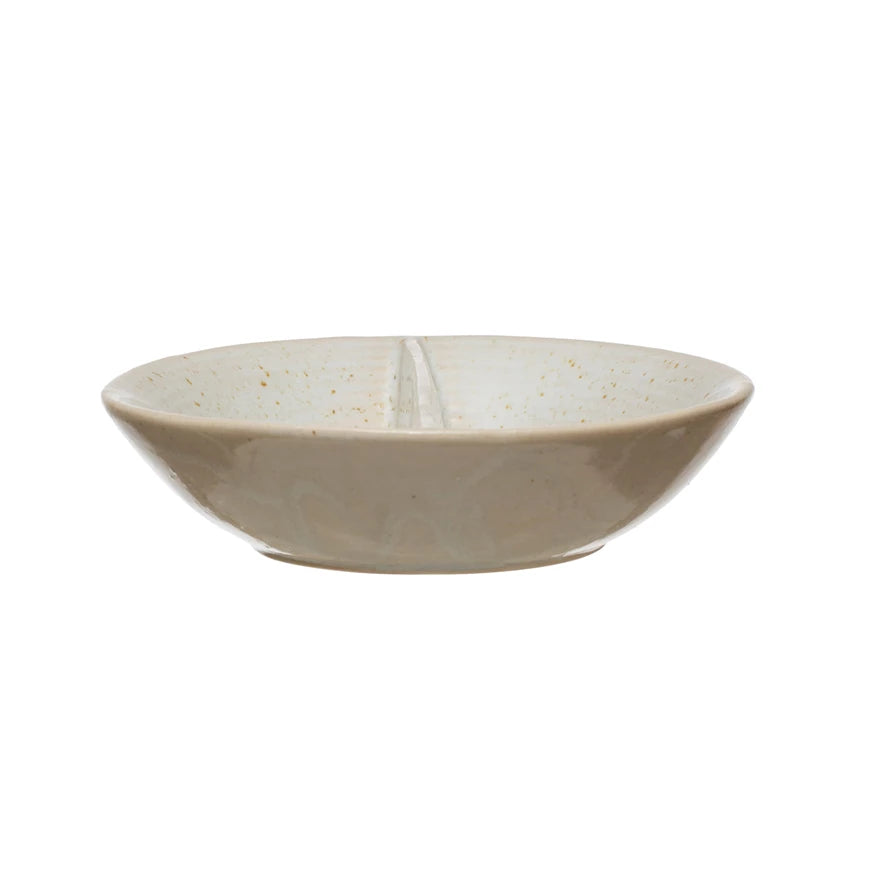side view of small dish with creamy speckled finish divided down the middle.