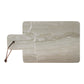 marble cheese cutting board with leather strap on a white background