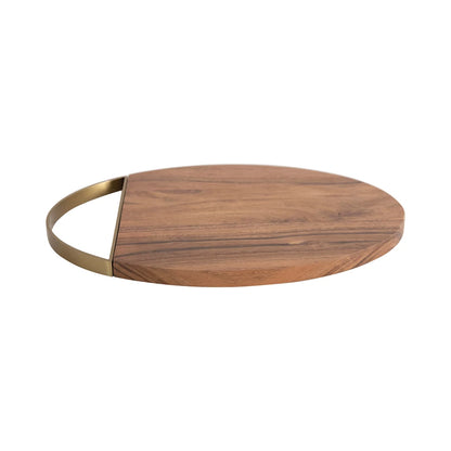 side view of oval wooden board with curved gold handle on one end on a white background.