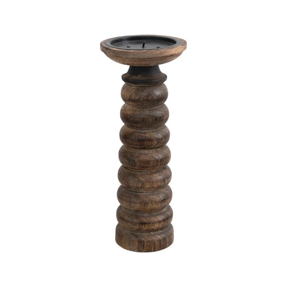 tall dark wooden candle stick with carved rings on a white background.