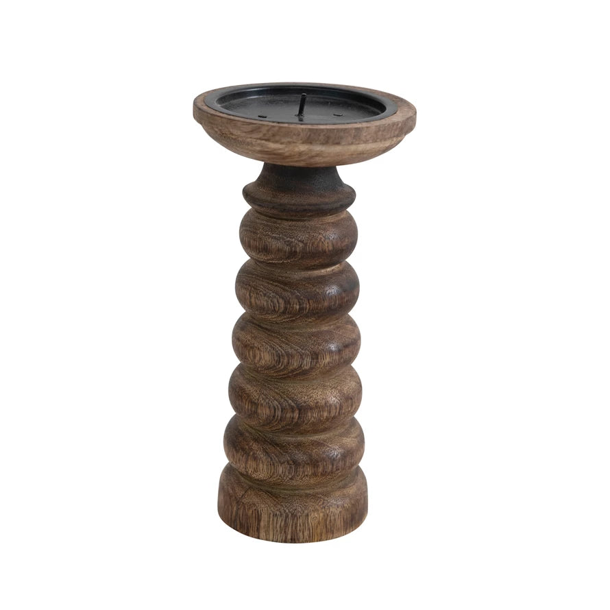 short dark wooden candle stick with carved rings on a white background.