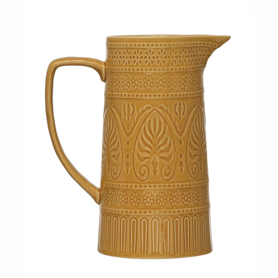 rich yellow embossed pitcher on a white background