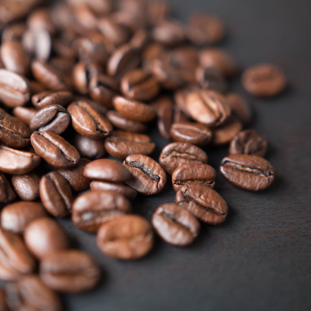 coffee beans on black countertop.