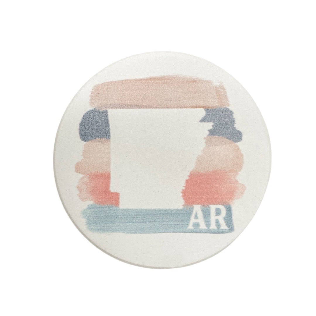 color block arkansas car coaster is the stare of arkansas outlined in pink, blue, and mauve and displayed on a white background