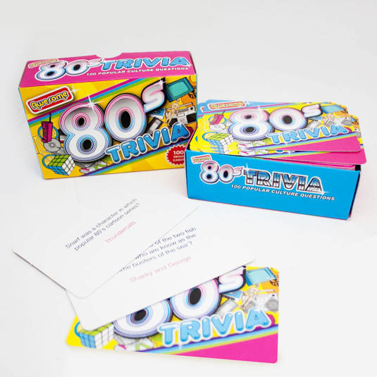 the awesome 80s package open displaying the trivia cards on a white background
