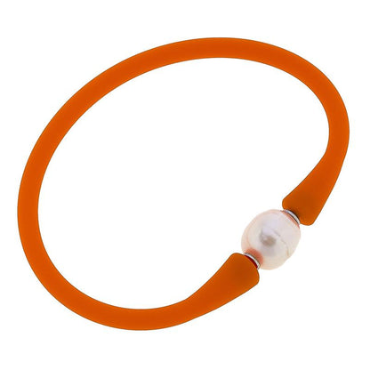 orange bali freshwater pearl silicone bracelet on a white background