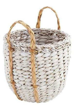 small seagrass basket with handles on a white background