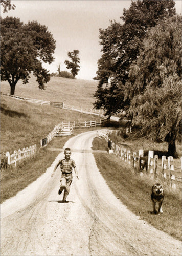 front of card is a black and white photo of a boy running down a country lane with a dog