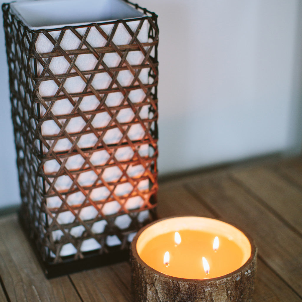 afternoon retreat candle sitting on a table next to decor 