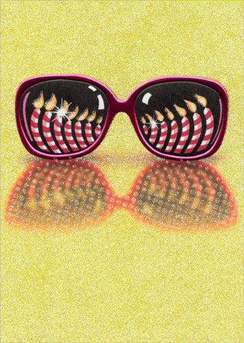 front of card with drawing of sunglasses with reflection of birthday candles in lenses