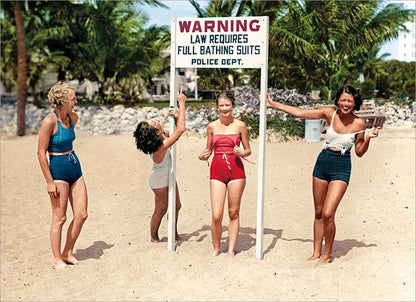 front of card has four women standing on a beach with a sign