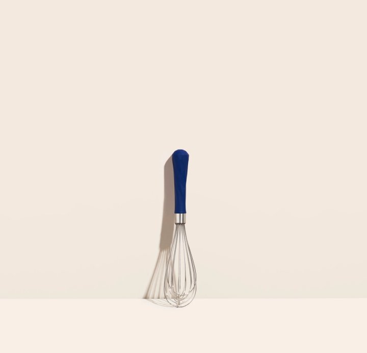 speckled navy starry night mini whisk displayed on a light pink background