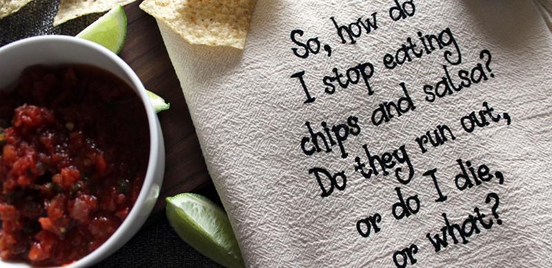 unbleached chips and salsa towel displayed on a board with a bowl of salsa lime wedges and chips