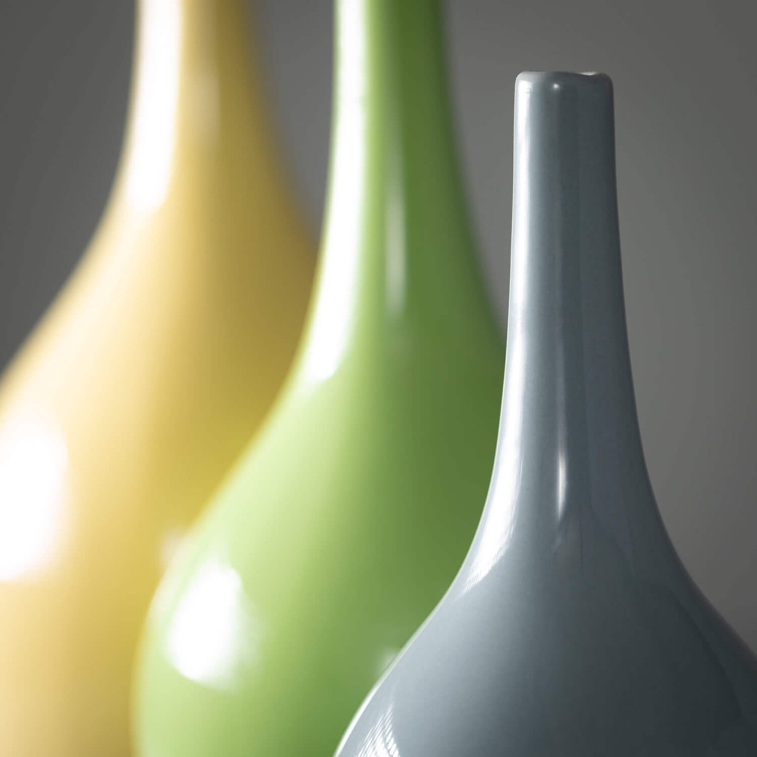 close up view of the necks of all three bright glossy vases