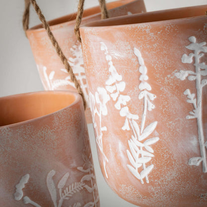 close-up of pots showing herb design.