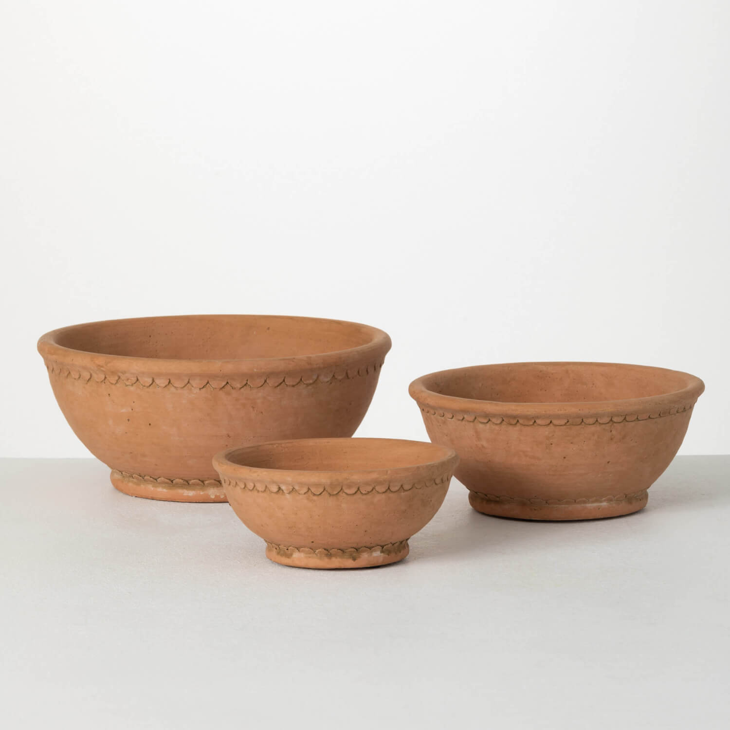 3 sizes of round shallow terracotta pots.