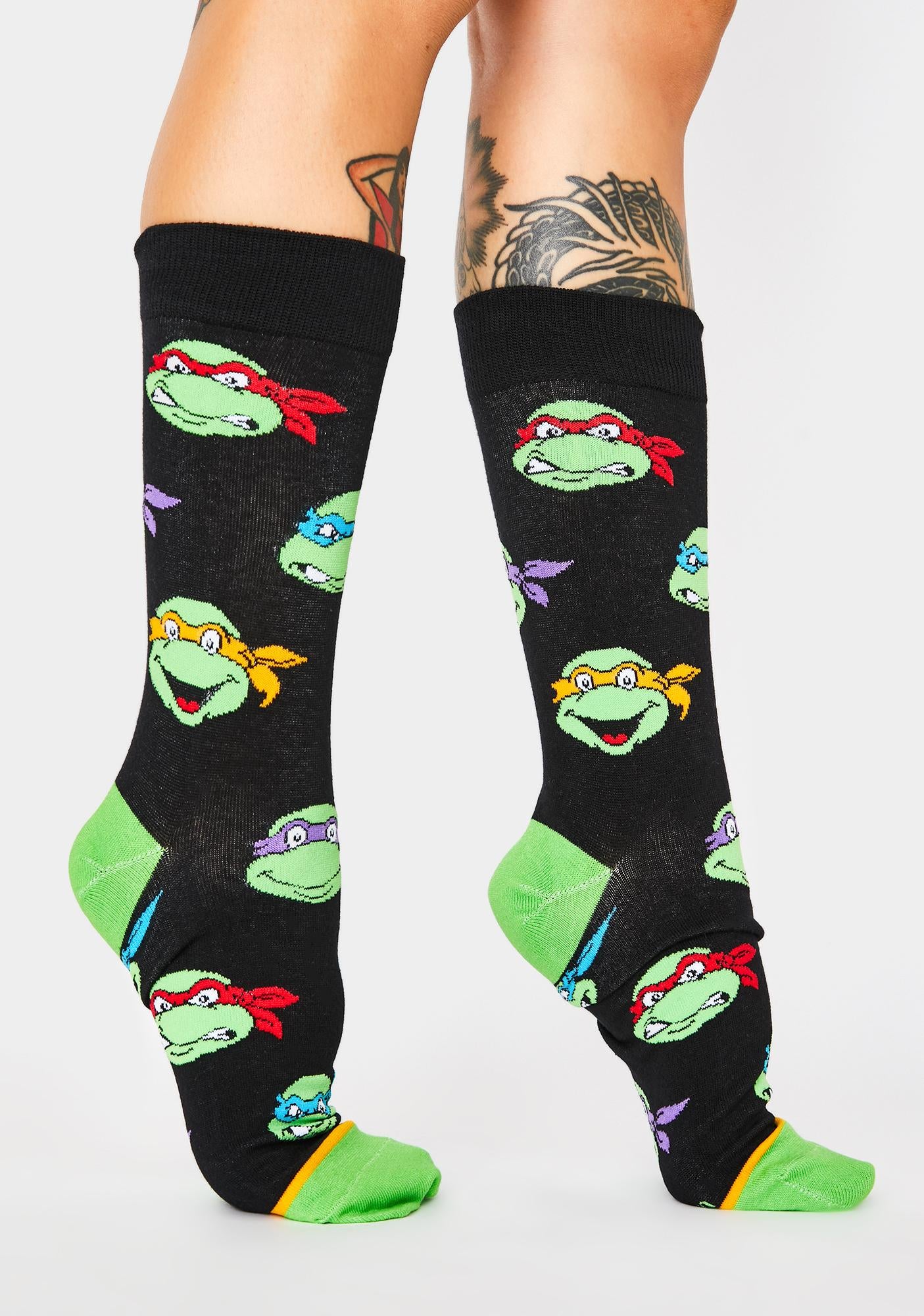 retro ninja turtles crew socks being worn by a person on a white background