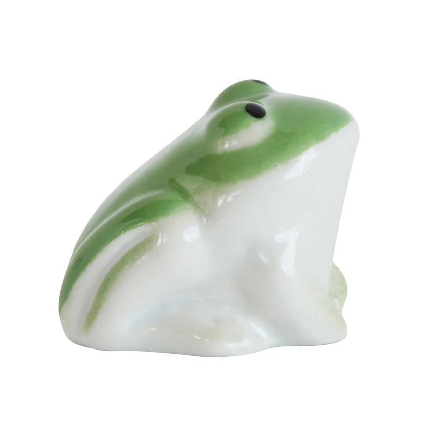 side view of ceramic frog that is white on the bottom half and green on top.