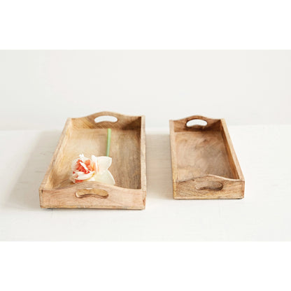 angled view of the small and large mango wood trays one holding a flower on a white background