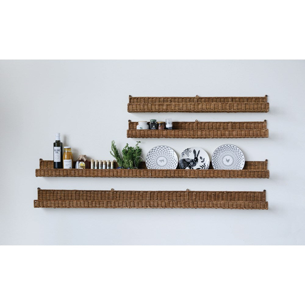 four hand woven rattan wall ledges displayed with decorative plates and greenery against a light gray background