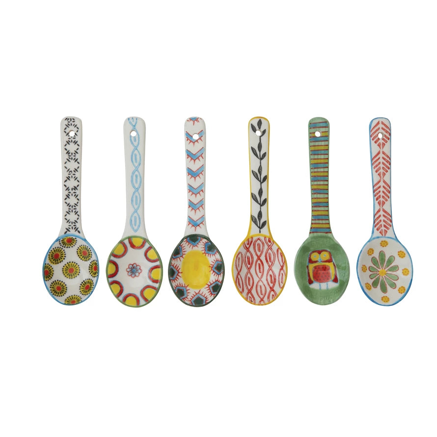 row of 6 spoons with colorful geometric patterns in the bowl and handle.