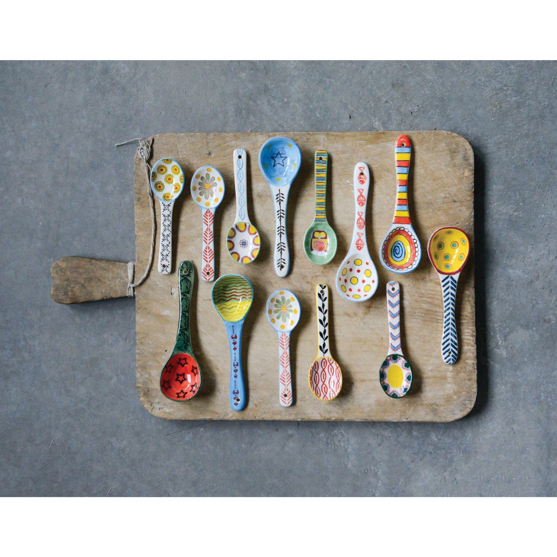 colorful spoons arranged on a wooden board.