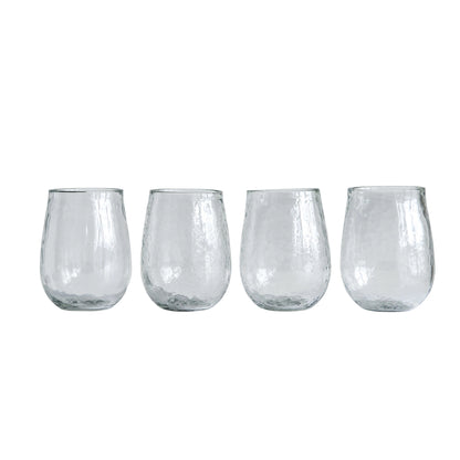 four recycled glass stemless wine glasses on a white background
