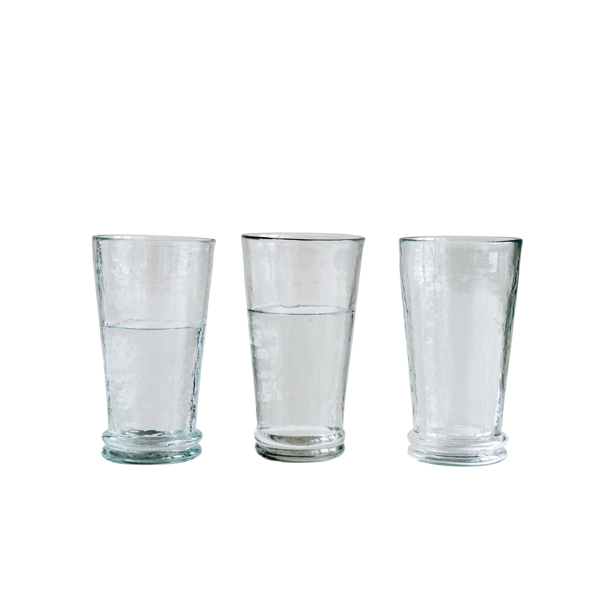 three recycled drinking glasses lined up against a white background