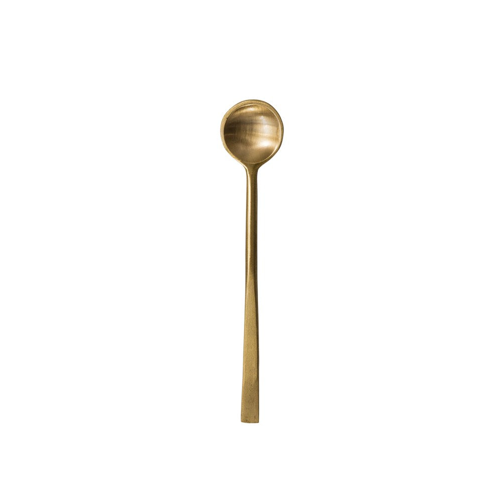 brass spoon with antique finish on a white background
