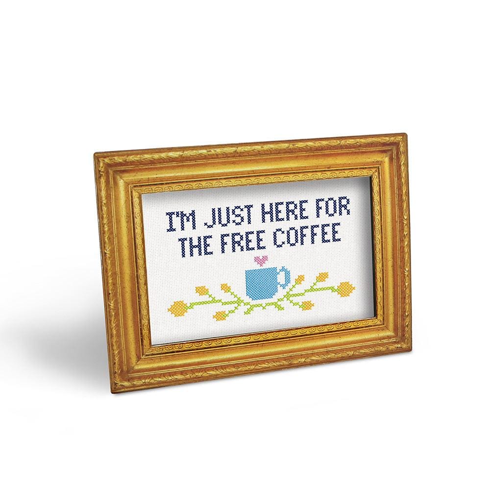 gold frame set horizontally with text "i'm just here for the free coffee".